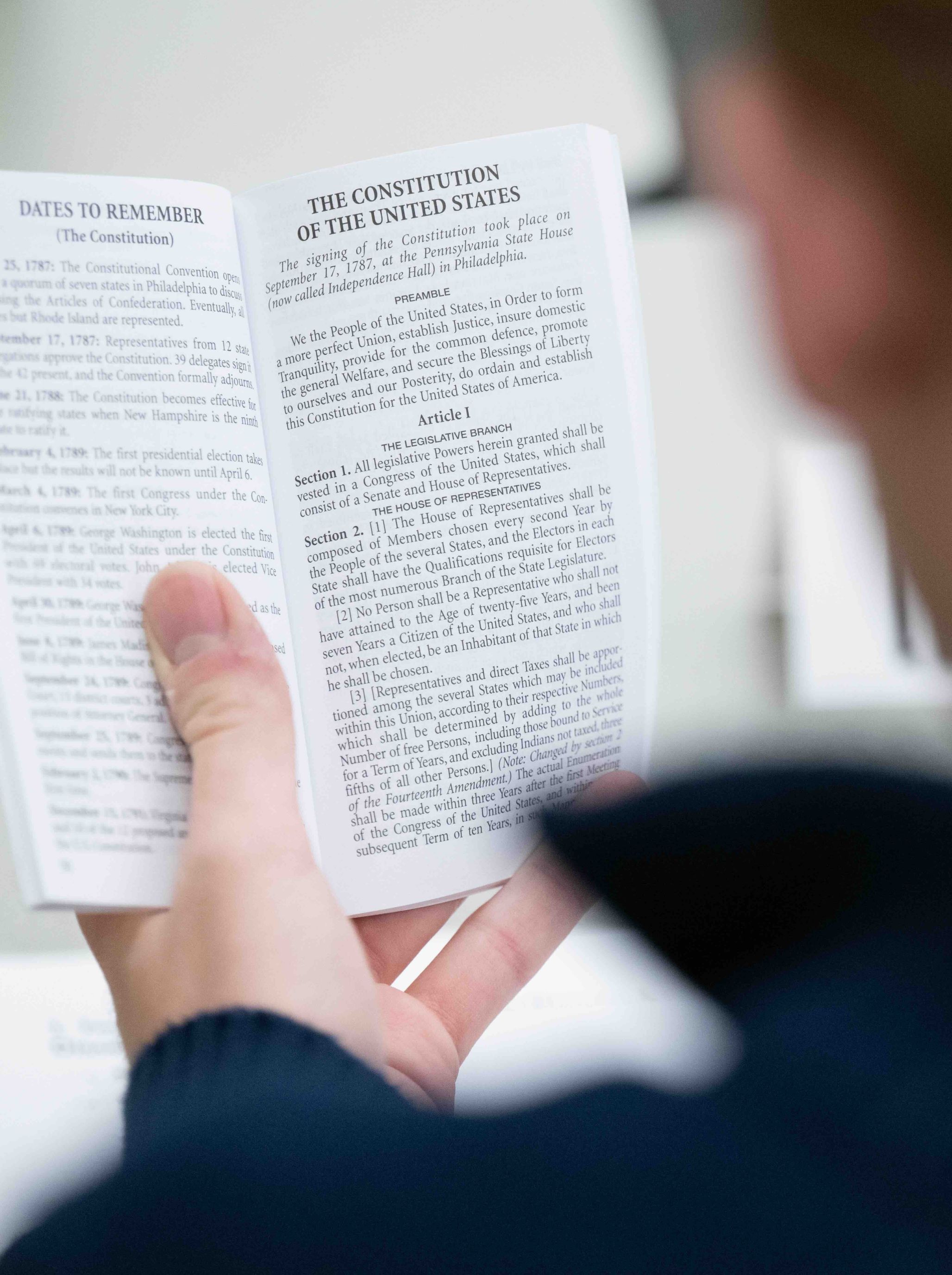 A man reading the United States Constitution at a JMC-sponsored event.