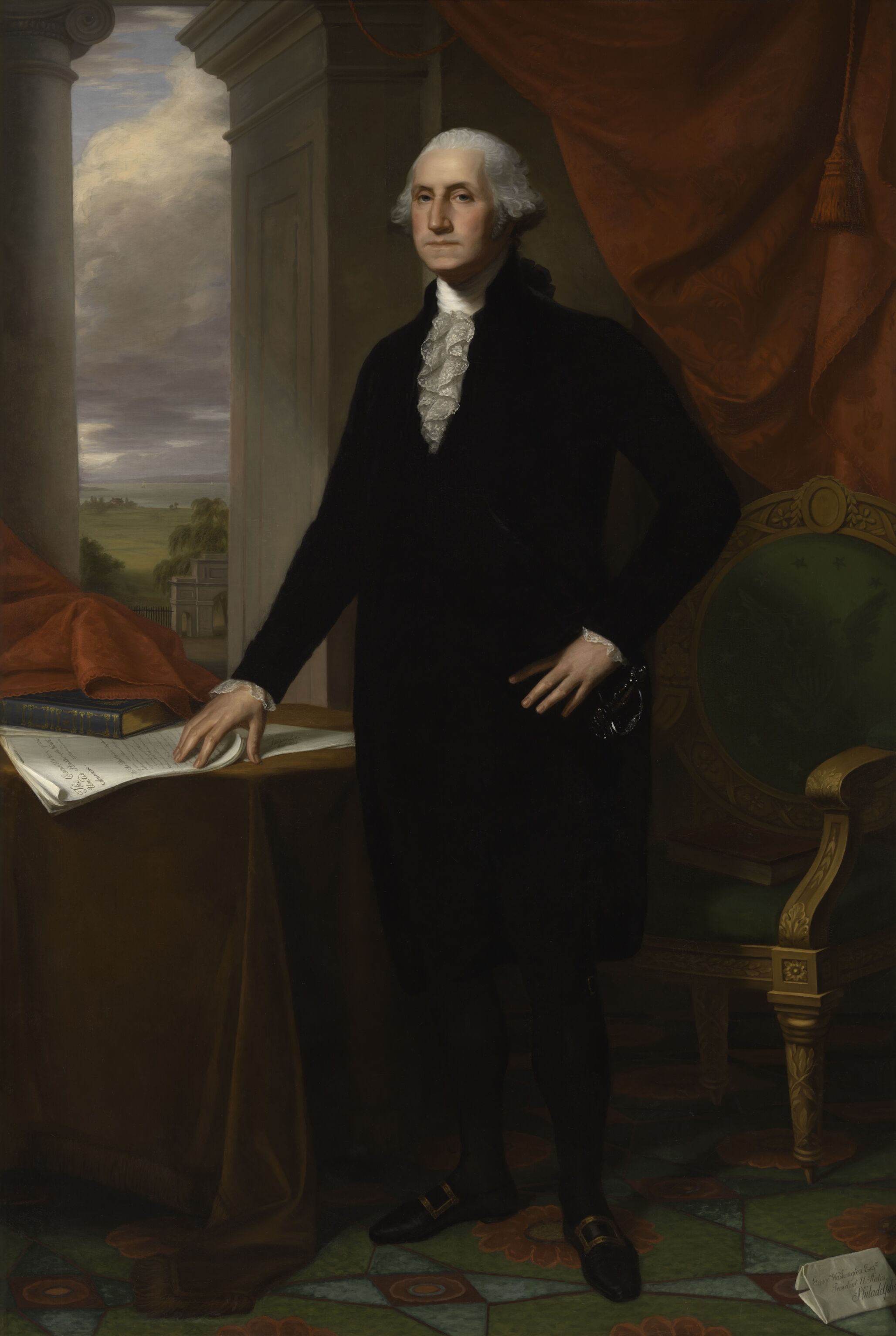 A senior George Washington stands near a table and window.
